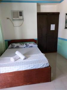 Ένα ή περισσότερα κρεβάτια σε δωμάτιο στο L&A Homestay in Siargao