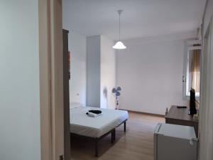 a room with a bed and a table in a room at Rooms for rent 67 in Sassari