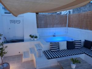 a patio with a hot tub and two benches at Corte Giotto Exclusive House in Carovigno