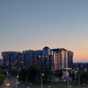 a large apartment building at night with a city at центр елітновобуд Яровиця 11 in Lutsk