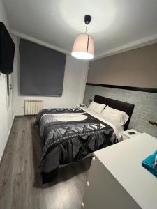 a bedroom with a bed and a projection screen at La Perla del Pirineo in Jaca