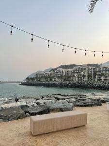 a bench on the beach with a string of lights at Sharm 3 Bedroom Luxury Apartment in Sharm