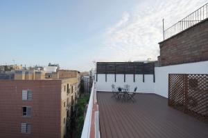 a balcony with a table on the roof of a building at numa I Lustre Apartments in Barcelona