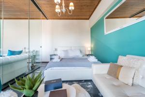 a bedroom with a bed and a couch at Aura Celestia in Kavála