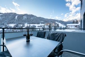 a table with two glasses of wine on a balcony at Alpex-Serfaus in Serfaus