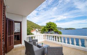 a balcony with chairs and a view of the water at Beautiful Home In Prizba With 7 Bedrooms And Wifi in Prizba