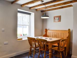 a dining room with a wooden table and chairs at Troedyrhiw Isaf in Tregaron
