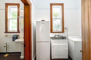a small kitchen with a refrigerator and a sink at Villa Florence in Martinborough +14 photos