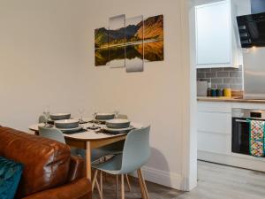 a dining room with a table and chairs at Howbeck Cottage in Hesket Newmarket