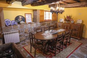 a dining room with a wooden table and chairs at Casa da Eira in Baião