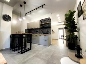 a kitchen with a island in the middle of a room at Tzoka Studio in Ierapetra
