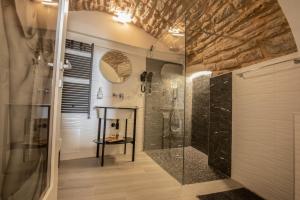 a bathroom with a shower and a glass shower stall at C'era una volta in Assisi