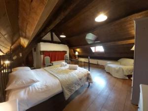 a bedroom with a large bed in a attic at Longhouse - Hen Dy in Rhayader