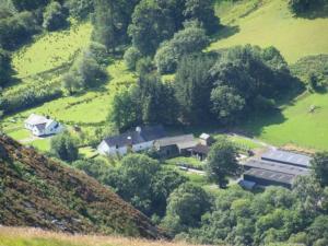 an aerial view of a house on a hill at Longhouse - Hen Dy in Rhayader +11 photos