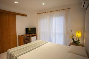 Cama ou camas em um quarto em Juquehy Praia Hotel