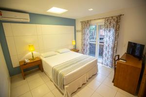 Cama ou camas em um quarto em Juquehy Praia Hotel
