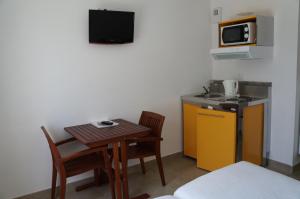 ein kleines Zimmer mit einem kleinen Tisch und einer Küche in der Unterkunft Hotel et Studios Le Marina Baie de La Baule in Pornichet