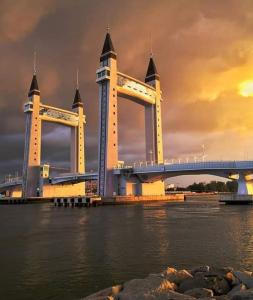 a large bridge over the water with a cloudy sky at Anggerik Camelia Homestay Apartment Ladang Tok Pelam FREE WIFI in Kuala Terengganu