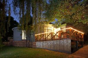 a house with lights on the side of it at Cango Retreat Quiet in Oudtshoorn
