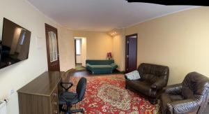 a living room with two leather chairs and a couch at ARB Kaunas in Kaunas