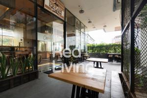 a restaurant with a wooden bench in front of a window at RedLiving Apartemen Evenciio - WIN Property Tower 1 in Depok