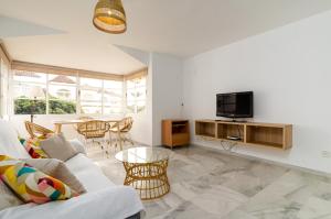 ein Wohnzimmer mit einem Sofa und einem TV in der Unterkunft San Paul del Mar Norte in Marbella