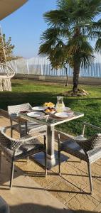 una mesa con un plato de comida y dos sillas en Alex Beach Apartment en Sveti Vlas
