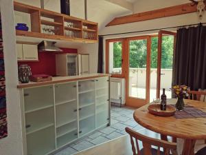 a kitchen with a table and a dining room at Karwendelglück in Scharnitz