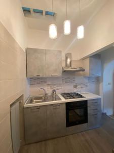 a kitchen with a sink and a stove at La casa di Peppe e Lucia in Poggio Bustone +11 photos