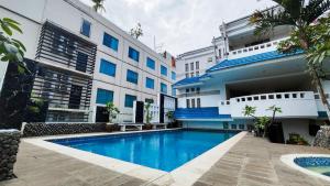 a swimming pool in front of a building at 1O1 URBAN Jakarta Thamrin in Jakarta