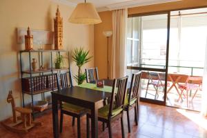 a dining room with a table and chairs and a balcony at El Apartamento de Trini in Seville