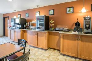 a kitchen with wooden cabinets and a counter top at Sleep Inn & Suites Sheboygan I-43 in Sheboygan