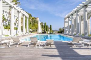 a swimming pool with lounge chairs and a building at Superbe appartement Cap de nice in Nice