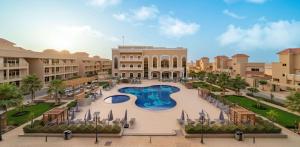 an aerial view of a resort with a swimming pool at Radisson Hotel Riyadh Airport in Riyadh