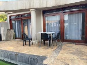 a table and chairs sitting on a patio at Royal View Cottage in Hartbeespoort