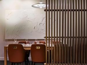 a dining room with a table and two chairs at The Porter House Hotel Sydney - MGallery in Sydney