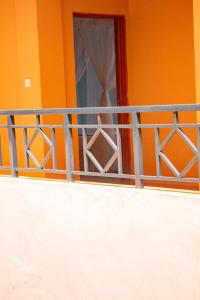 an orange house with a window and a fence at Deka Self Contained Rooms in Nairobi