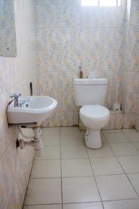 a bathroom with a toilet and a sink at Deka Self Contained Rooms in Nairobi