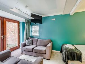 a living room with a couch and a bed at The Wing At Brook Hall in Newton Kyme