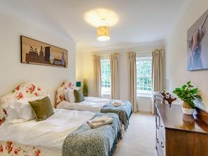 a bedroom with two beds and a desk at The Wing At Brook Hall in Newton Kyme