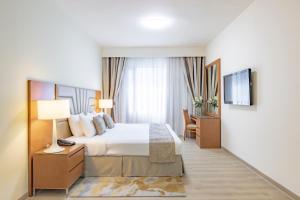 Postel nebo postele na pokoji v ubytování Golden Sands Suites