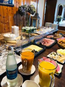 a table with a buffet of food and drinks at Hotel Altstadt Wöllbacher Tor in Wetzlar