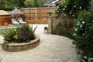 a backyard with a garden with flowers and a fence at Richmond Lane Guest House - AA Accredited in Romsey +26 photos