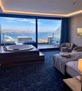 a hotel room with a tub and a large window at Ring Stone Hotels Bosphorus - Special Class in Istanbul