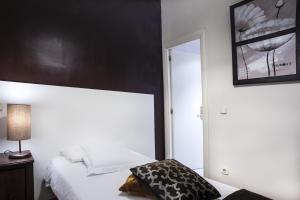 a hotel room with a bed and a mirror at THC Gran Via Hostel in Madrid