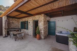 an outdoor patio with a table and a bath tub at Lefkara Luxury Suites in Pano Lefkara