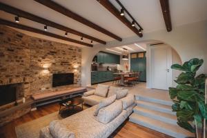 a living room with two couches and a fireplace at Lefkara Luxury Suites in Pano Lefkara