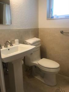 a bathroom with a white toilet and a sink at Efficiency 3 on water Las Olas beach and free kayaks in Fort Lauderdale