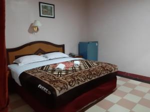 Postel nebo postele na pokoji v ubytování Hotel Parewisata