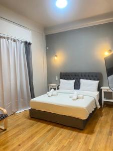 um quarto com uma cama grande com duas toalhas em Athens City Themis13 em Atenas